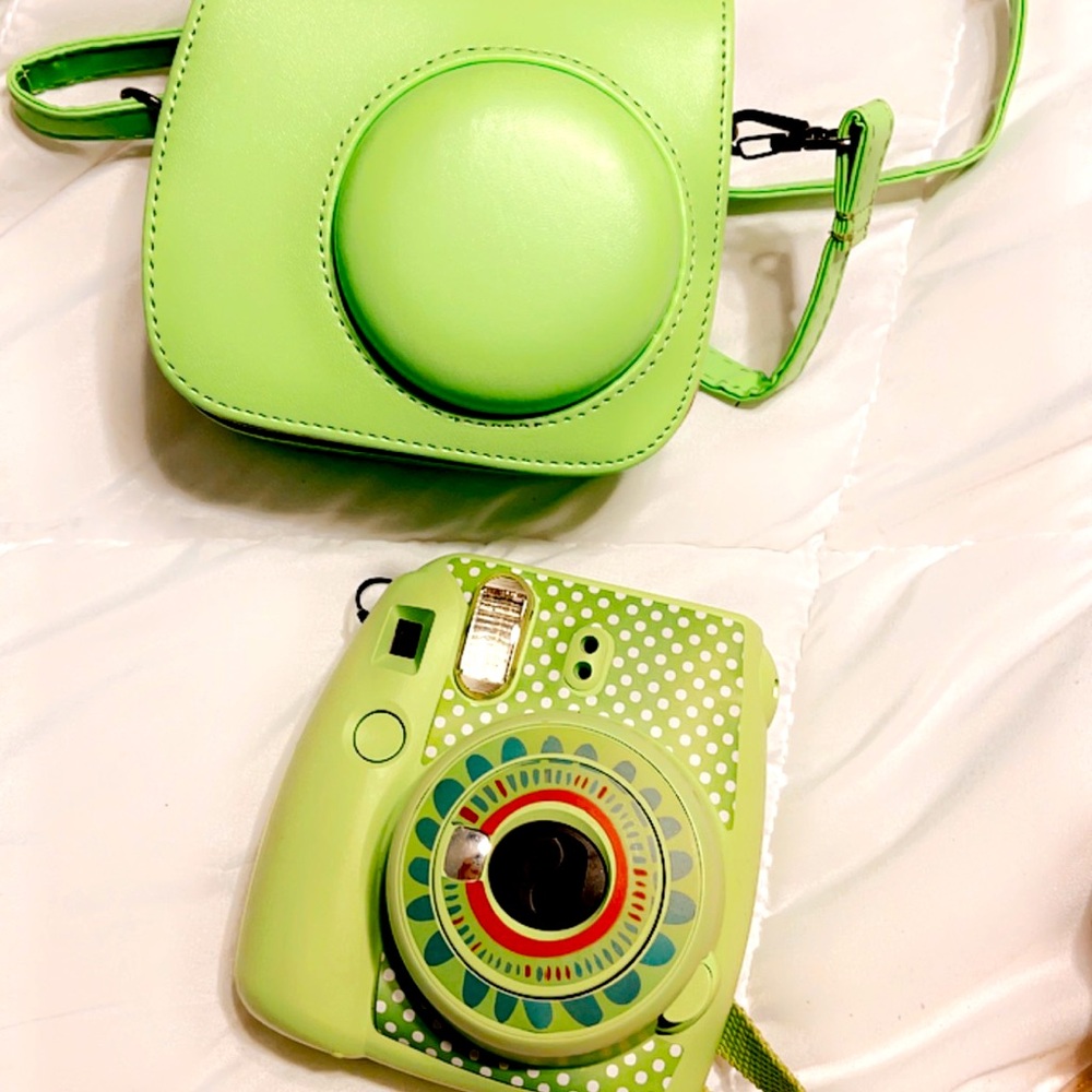 Polaroid camera ; w case and sticker on it
